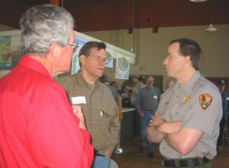 Shane Spitzer (right), scientist at the Shenandoah National Park, talks with Rappahannock farmers Clyde Humphrey (left) and Cliff Miller (middle) at the April 2003 RappFLOW Public Forum on Air and Water Quality in the Shenandoah National Park. 